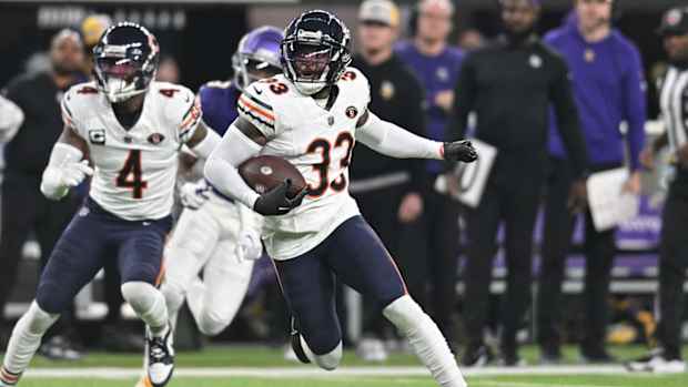Nov 27, 2023; Minneapolis, Minnesota, USA; Chicago Bears cornerback Jaylon Johnson (33) returns an interception as safety Eddie Jackson (4) looks on against the Minnesota Vikings during the second quarter at U.S. Bank Stadium. Mandatory Credit: Jeffrey Becker-USA TODAY Sports